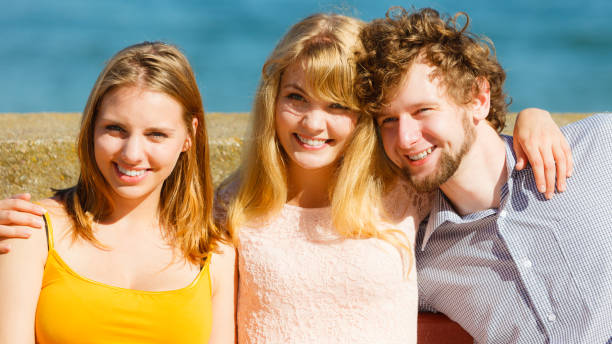 istock Three happy young people friends outdoor. 683424272