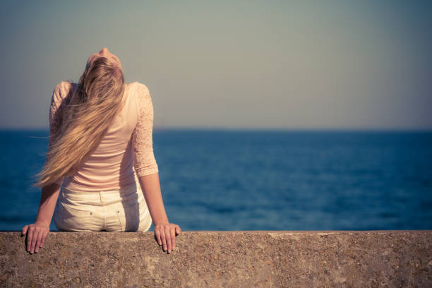 istock Woman looking to sea horizon 683424324