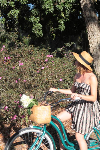 istock Woman riding bicycle in a tropical park. 683428060