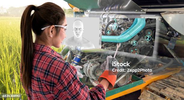 Augmented Reality Glasses Technology Smart Agriculture Farm Artificial Intelligence Adviser Industry 40 Conceptyoung Female Farmer Use Ar Glasses To Fix Tractor Car Machine With Digital Screen Stock Photo - Download Image Now