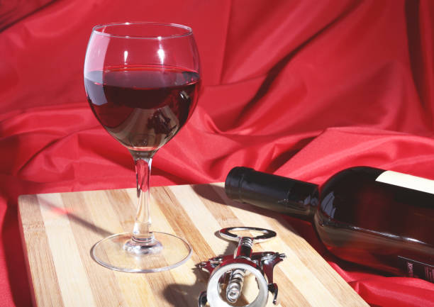 istock Botle with red wine grapes and chees on wooden table. 683431340