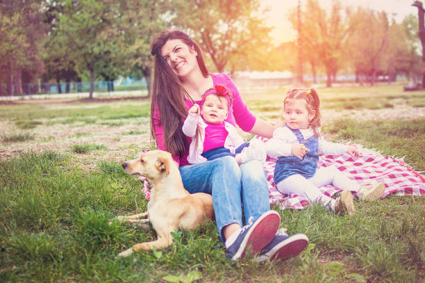 istock Mom, daughters and dog smilling 683441556