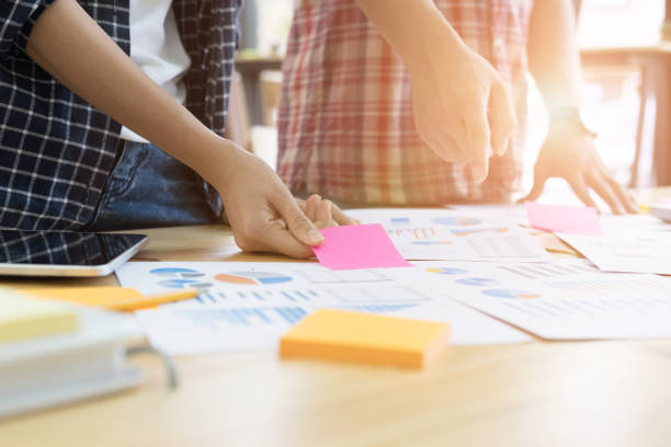 istock startup young successful team on meeting in modern office interior brainstorming, make a business plan, working on tablet with financial and marketing graph and chart 683444614