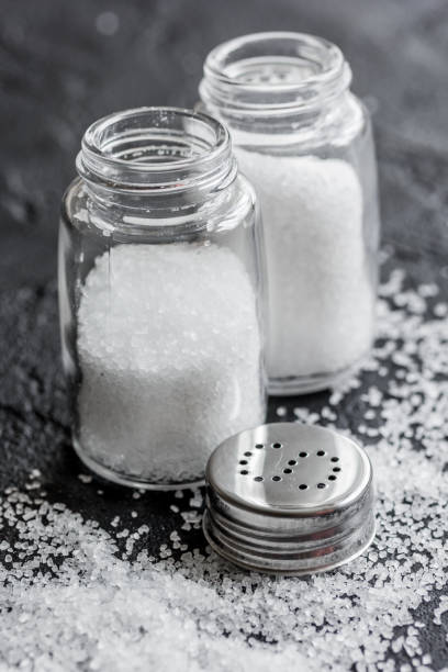 istock Spices set with salt in glass bottles for cooking on stone background 683450976