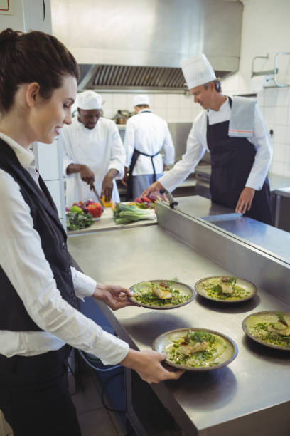 istock Waitress taking food dishes from order station 683451340