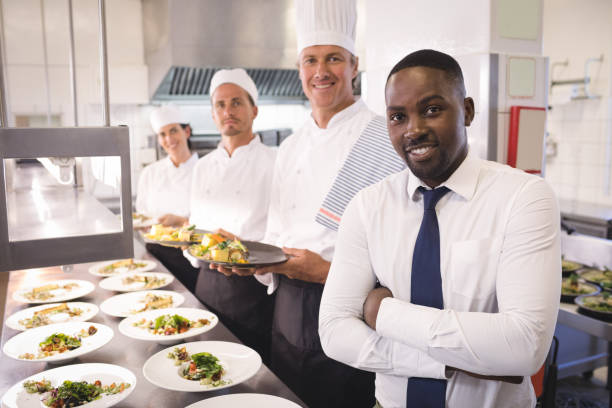 Restaurant manager with his kitchen staff stock photo