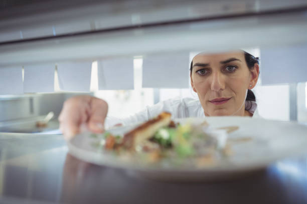 istock Waitress taking food dishes from order station 683455006