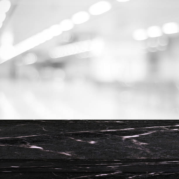 istock Empty black marble over blur store background, product and food display montage 683455104