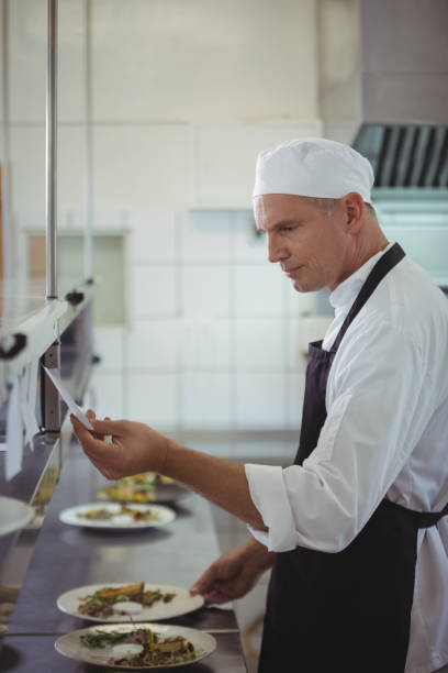 istock Chef looking at an order list in the commercial kitchen 683455638
