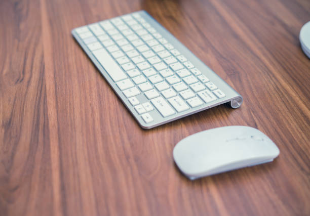 istock White wireless keyboard and wireless mouse on the wooden table 683461696