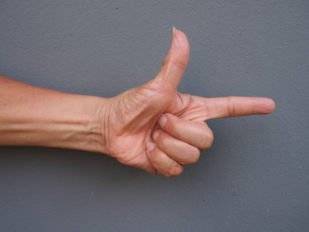 istock a hand making a shape of a pointing hand on gray background 683462154