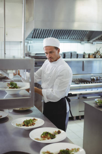 istock Chef looking at an order list in the commercial kitchen 683462582