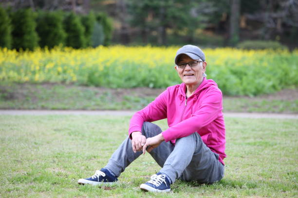 istock senior Japanese man sitting on a lawn 683471968