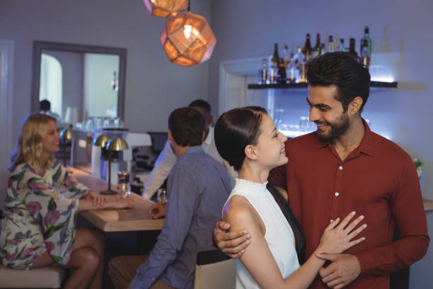 istock Couple embracing each other at bar restaurant 683471998