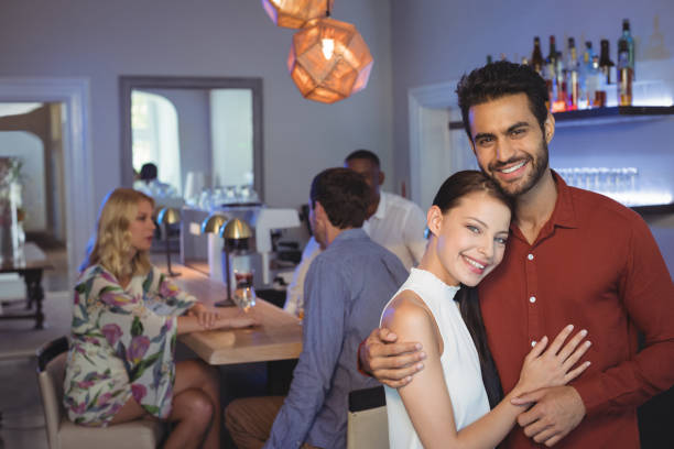 istock Smiling couple embracing each other at bar restaurant 683472036