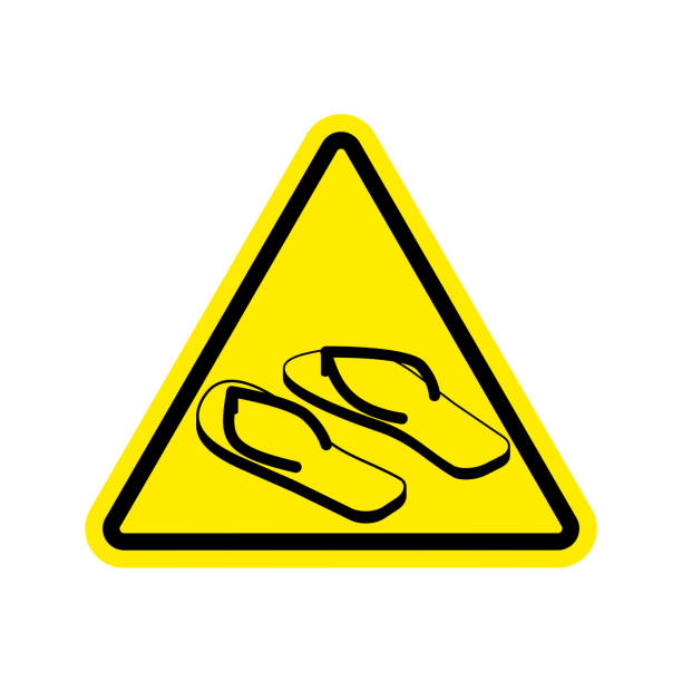 istock Attention slippers. Caution beach shoes. Yellow triangle road sign 683475824