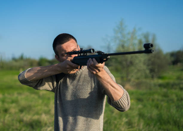istock The man takes aim at the target with a sniper rifle. Selective Focus 683479438