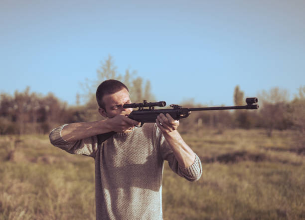 istock The man takes aim at the target with a sniper rifle. Selective Focus 683479468