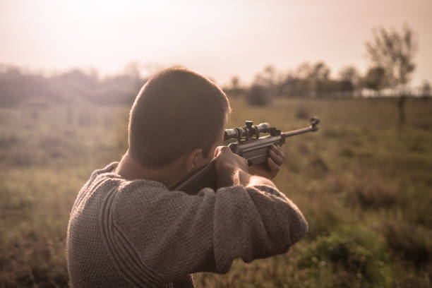 istock The man takes aim at the target with a sniper rifle. Selective Focus 683479494