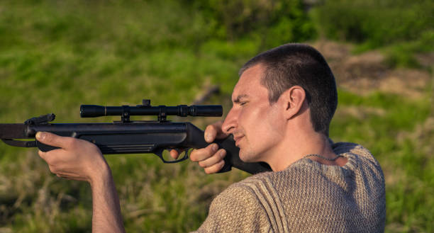 istock The man takes aim at the target with a sniper rifle. Selective Focus 683479512
