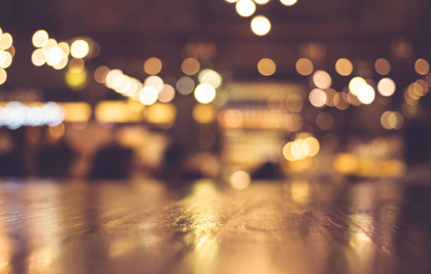 istock Wood table with blur light in night cafe,restaurant background 683480214