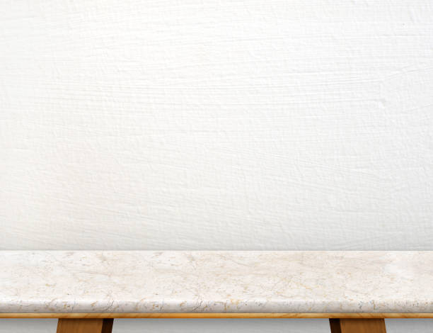 istock Empty cream marble table top with white concrete wall,Mock up for display or montage of product,use as background 683480420