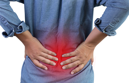 Midsection Of Woman Suffering From Backache, Standing Against White Background