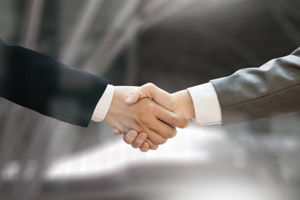 istock M&A (MERGERS AND ACQUISITIONS) , Businessman handshake working at office M&A 683501134