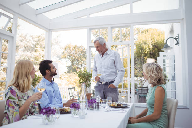 istock Group of friends interacting with each other while having meal together 683511872