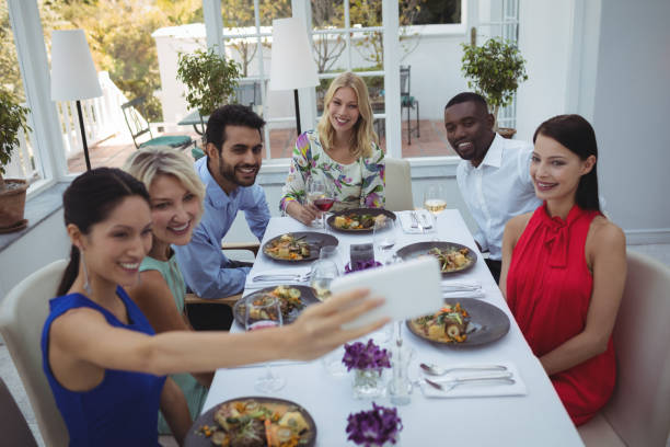 istock Friends taking selfie on mobile phone while having meal 683515602