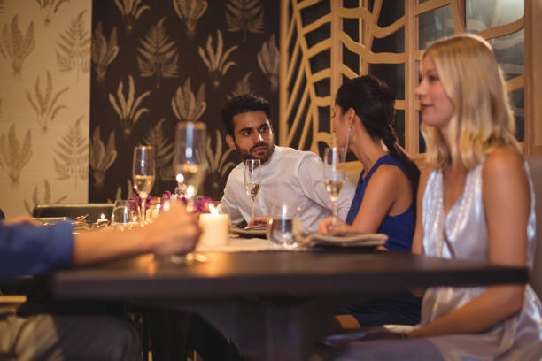 istock Happy friends interacting with each other while having champagne 683519700