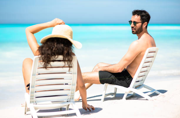 istock happiness couple sunbathing on the beach 683522532