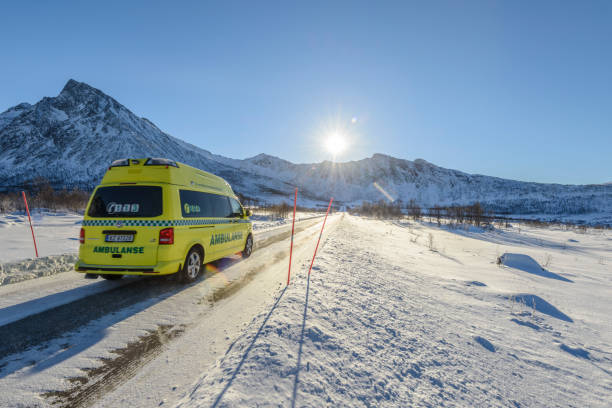 Ambulance driving in a winter landscape in Norther Norway Ambulance driving in a winter landscape in Norther Norway during a beautiful winter day near the village of Gryllefjord on the island Senja.. senja island photos stock pictures, royalty-free photos & images