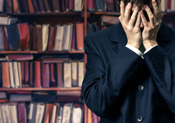 Businessman in despair on paper archive background