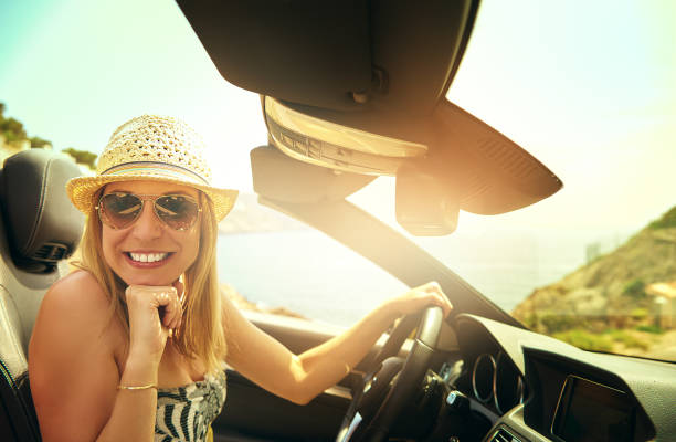 istock Cute woman driving convertible car 683524066