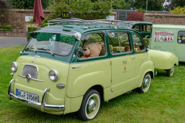 Falun, Sweden - july 25,2012 A car enthusiast driving his fully restored blue Fiat 600 D from 1961, in a classic car cavalcade around the small town on the public road in Falun Sweden