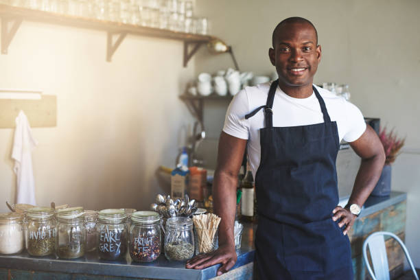 istock Handsome black entrepreneur stands by cafe counter 683527302