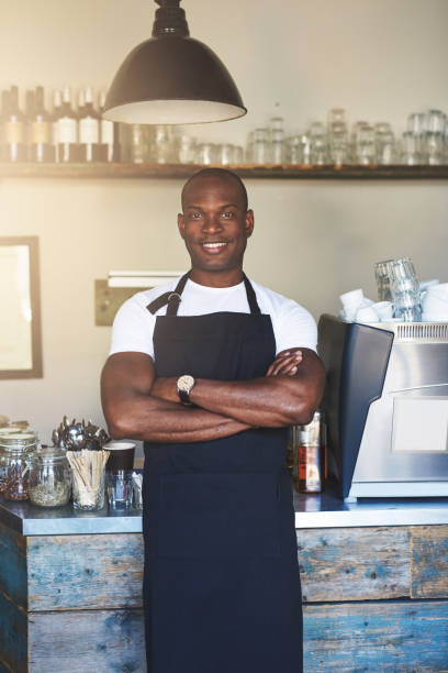 istock Handsome business owner stands by cafe counter 683527432