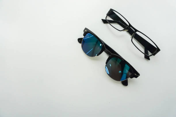 istock isolated sunglasses and modern men glasses on office desk 683527616