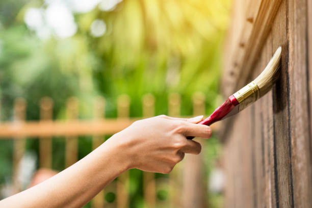 Applying protective varnish on a wooden texture