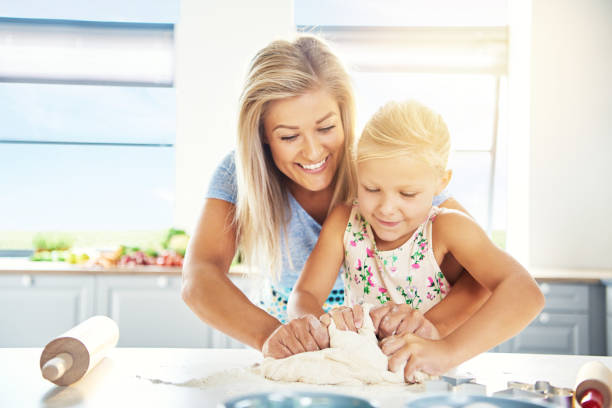 istock Adoring young mother teaching her daughter to bake 683534800