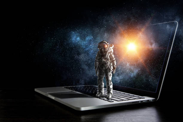 Space explorer and laptop. Mixed media stock photo