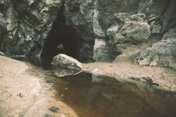 istock Dark water flowing out of the cave 683538502