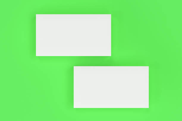 istock White blank business cards mock-up on green background 683539004