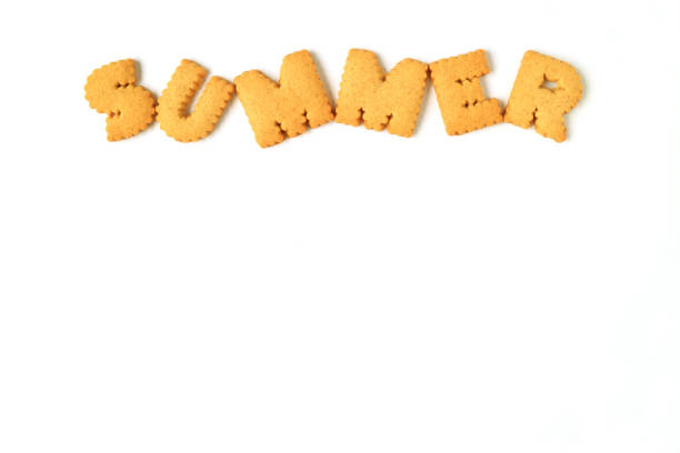 istock Top view of the word SUMMER, made with alphabet shaped biscuits isolated on white background, with free space for design 683539396