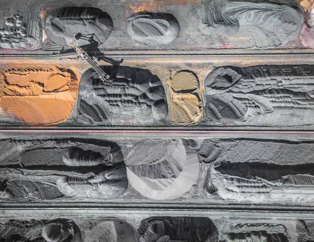 istock Brown coal deposits. Surface mine with exposed colored minerals and brown coal, mining equipment. View from above. 683540192
