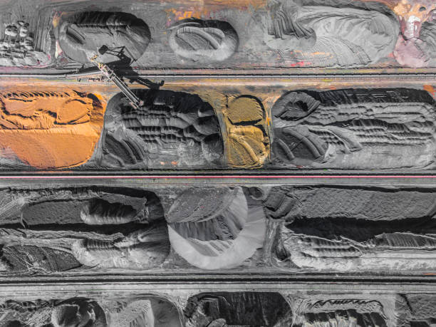 istock Brown coal deposits. Surface mine with exposed colored minerals and brown coal, mining equipment. View from above. 683540194