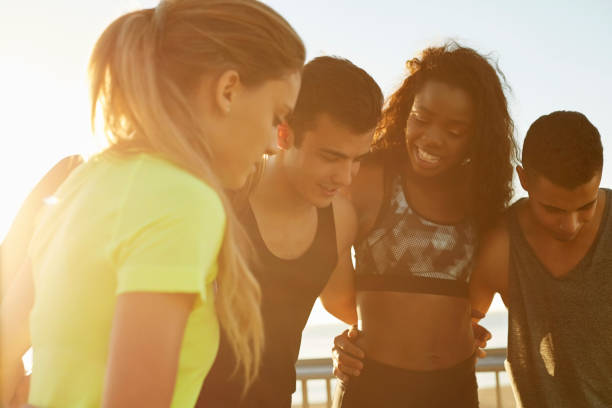 istock Friends standing with arms around during sunset 683549020