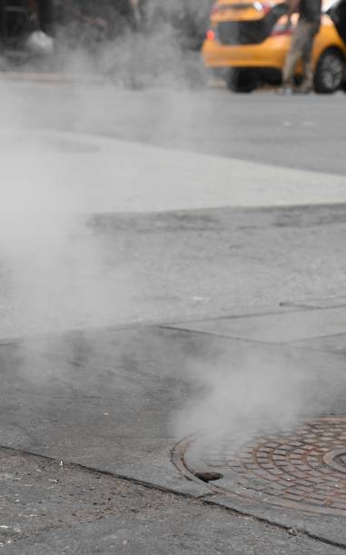 istock Smoke comes out of the sewage on the road 683551908