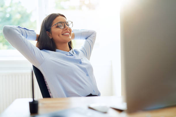 istock Woman with satisfied expression at desk 683553956